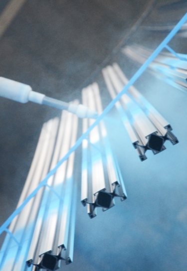 Keystone Koating employee spraying super durable polyester powder in demanding environment