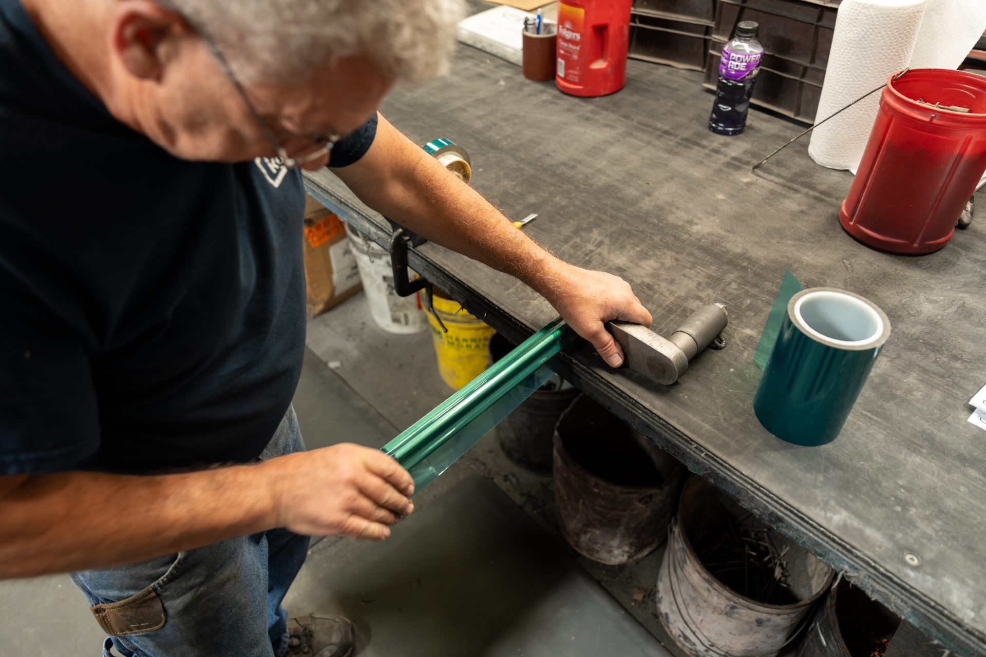 Close up of Keystone Koating employee masking a product to prepare for powder spraying