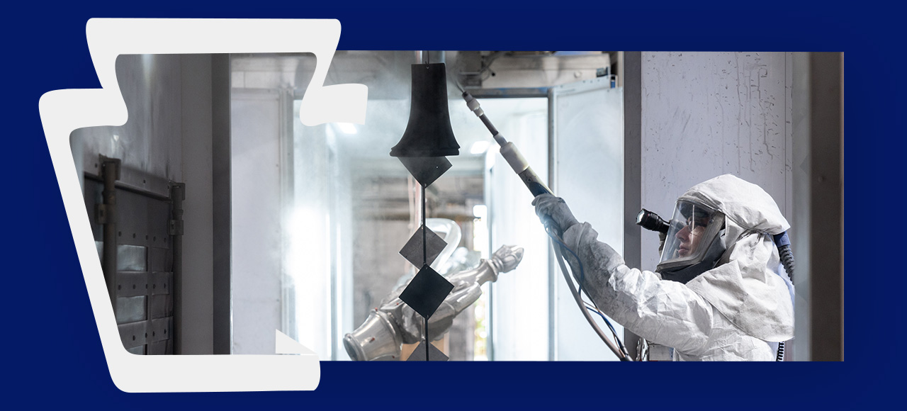 Keystone Koating employee spraying powder coating